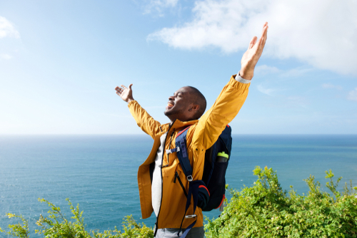 man with hands raised