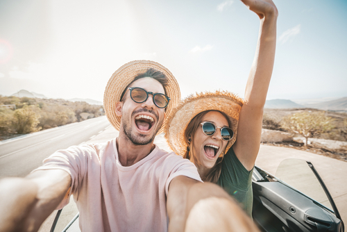 couple taking picture while driving 