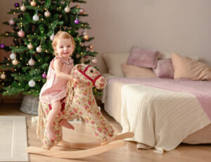 little girl on wooden horse 