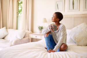 woman sitting on bed