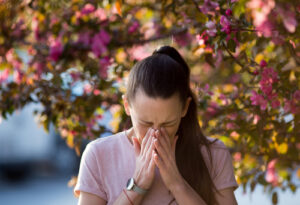 woman sneezing from allergies